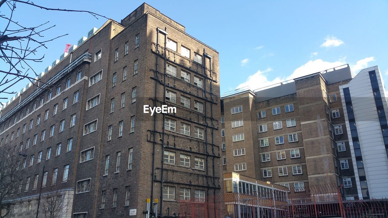 Low angle view of buildings in city against sky