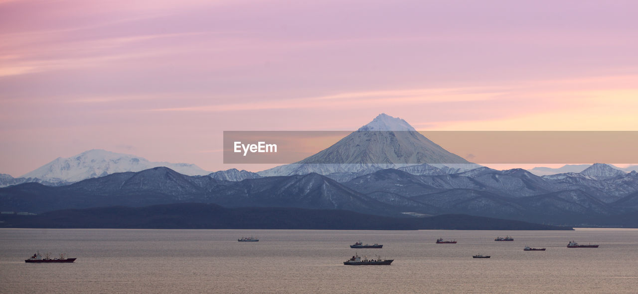 The fishing boats in the bay with the volcano on kamchatka