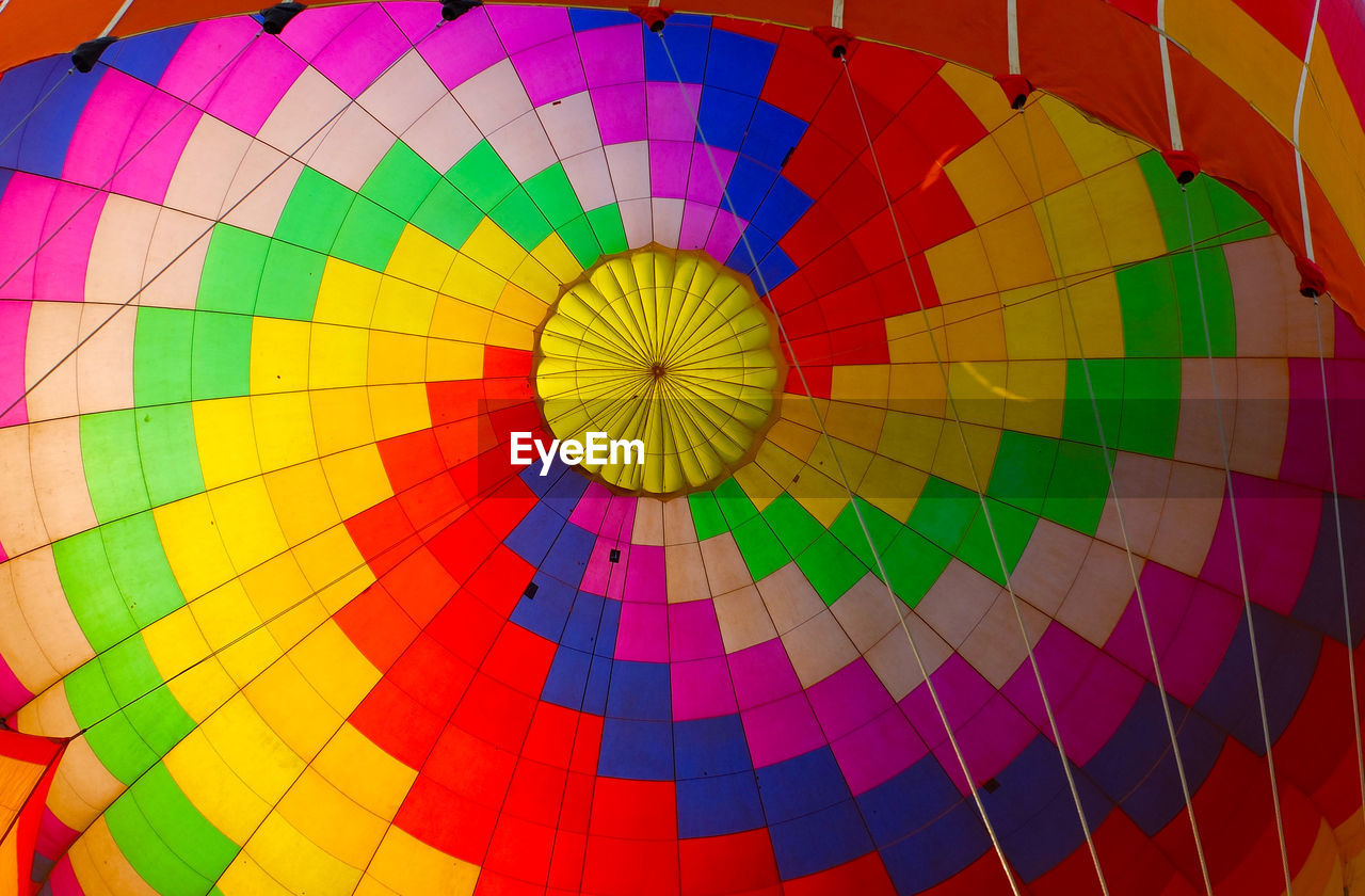 multi colored, hot air balloon, balloon, air vehicle, hot air ballooning, vehicle, aircraft, toy, transportation, ballooning festival, adventure, flying, pattern, inflating, executive car, mid-air, flame, basket, tradition, burning, traditional festival, fire, recreation, celebration, mode of transportation, taking off, heat, no people, travel, sports, variation, yellow, red, nature, circle, outdoors, backgrounds, extreme sports, low angle view, full frame