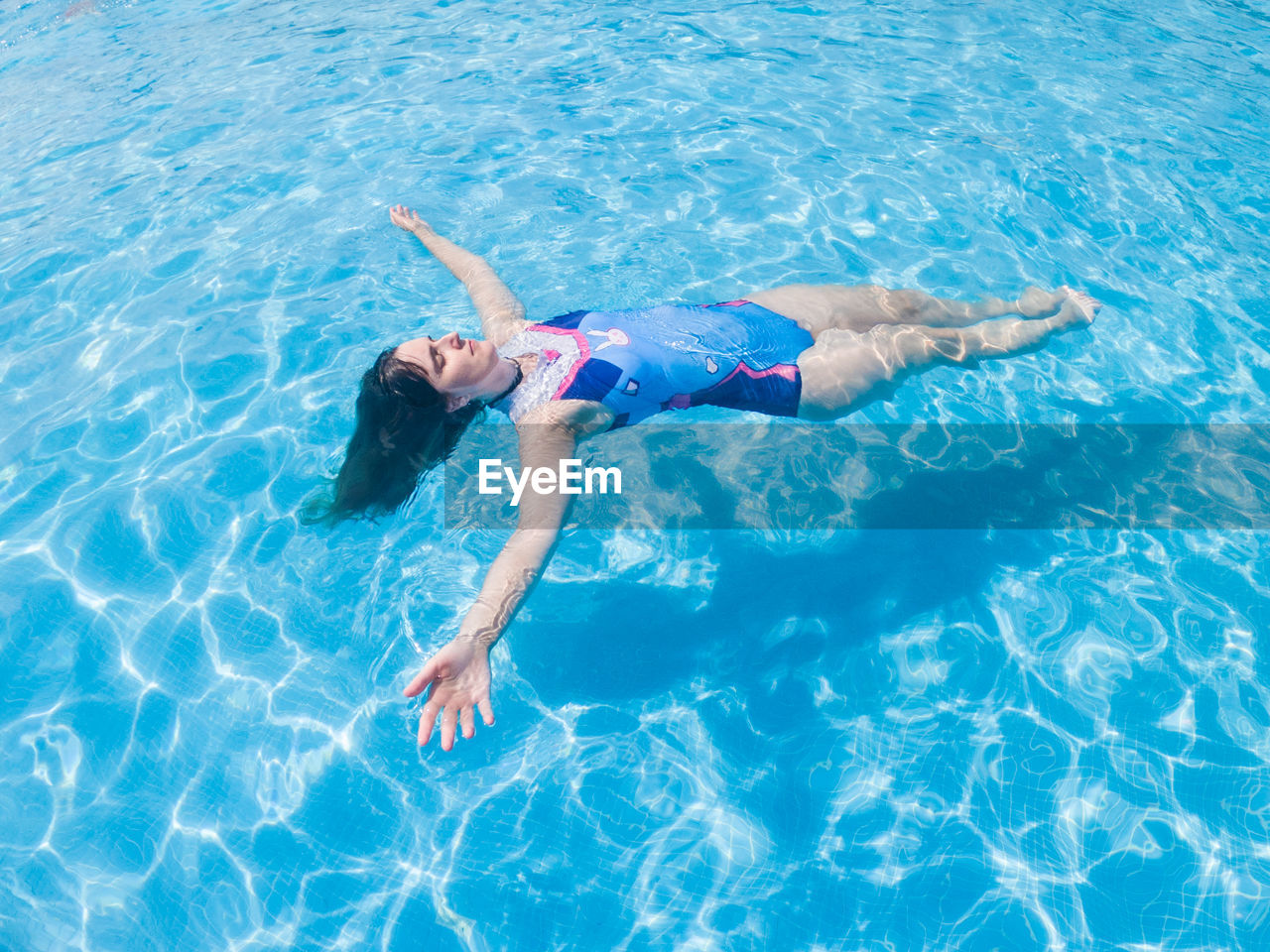 High angle view of woman swimming in pool