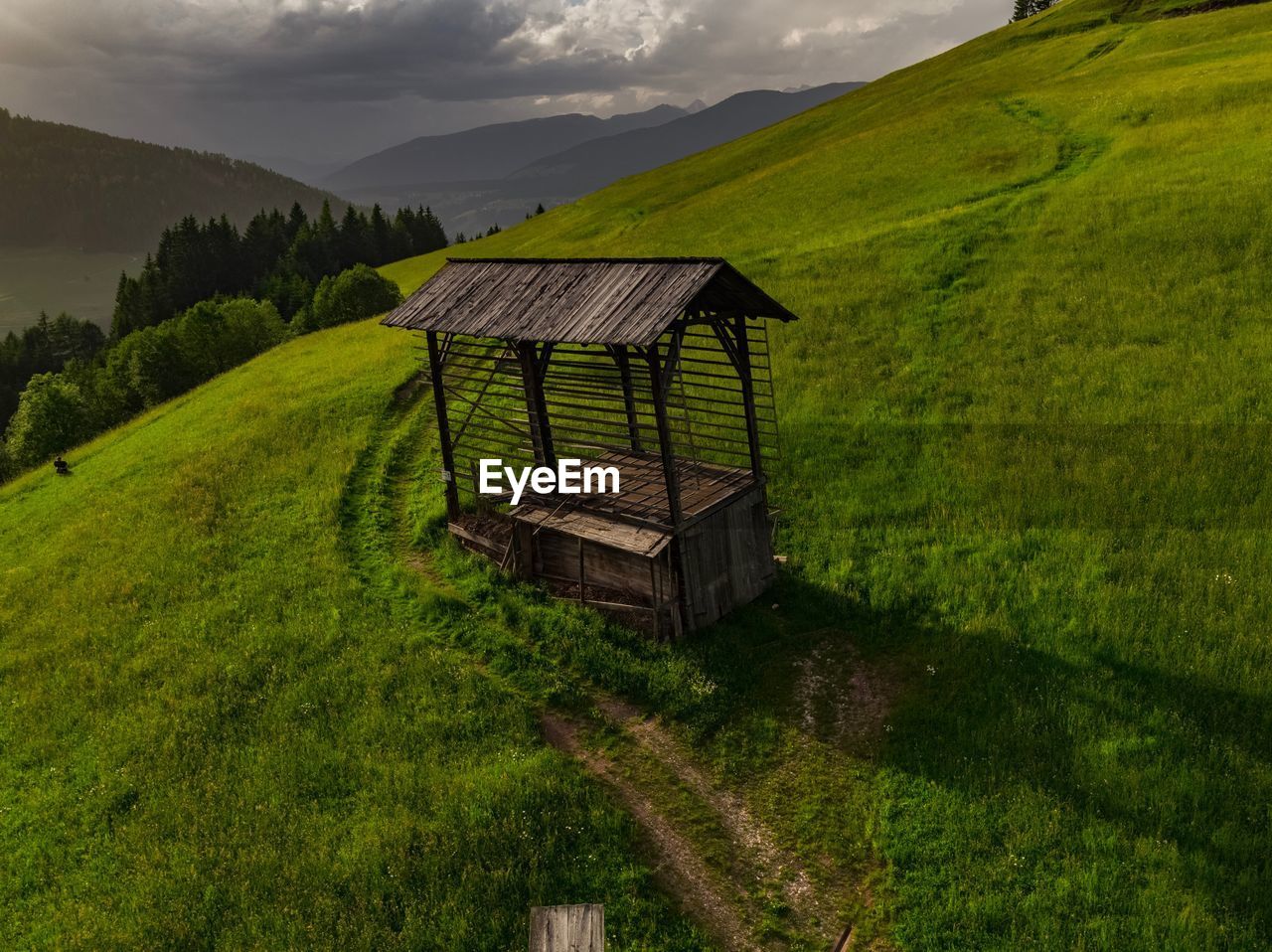 LIFEGUARD HUT ON FIELD AGAINST MOUNTAIN