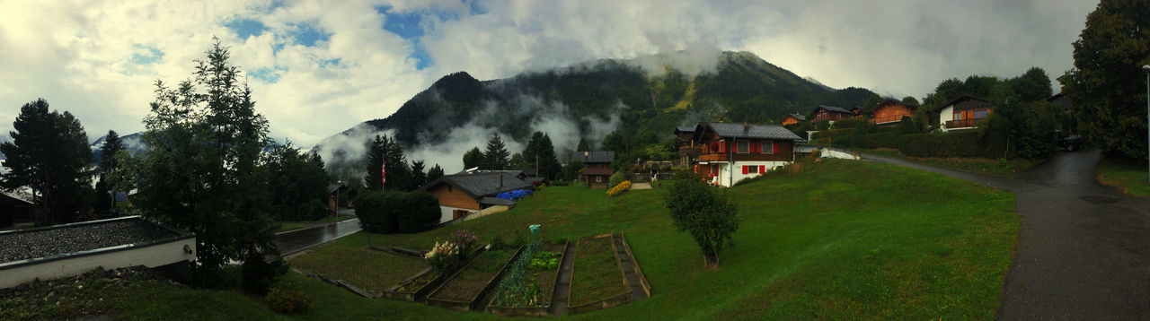 Panoramic view of houses and trees against sky