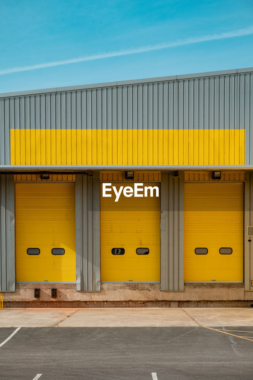 Yellow industrial buildings against blue sky 