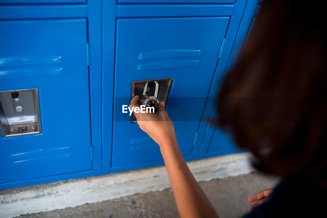 Closeup of a child locking her combination lock on her locker