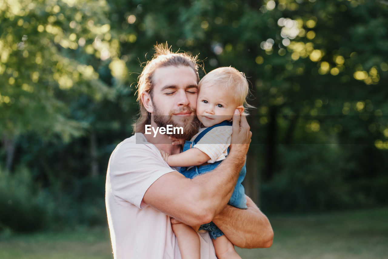 Father and son embracing at park