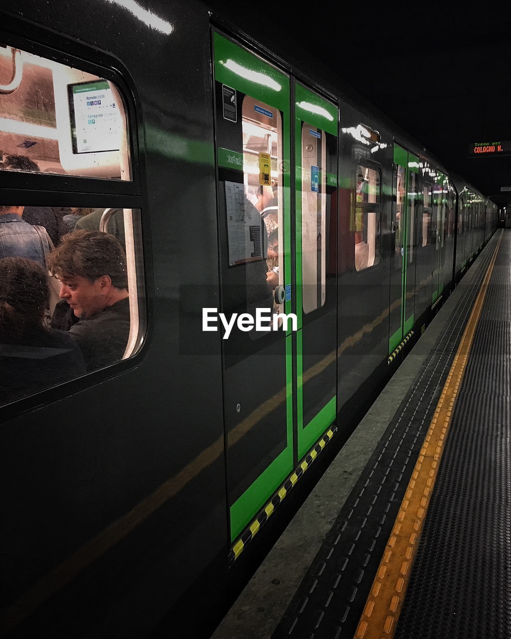 TRAIN PASSING THROUGH RAILROAD STATION PLATFORM