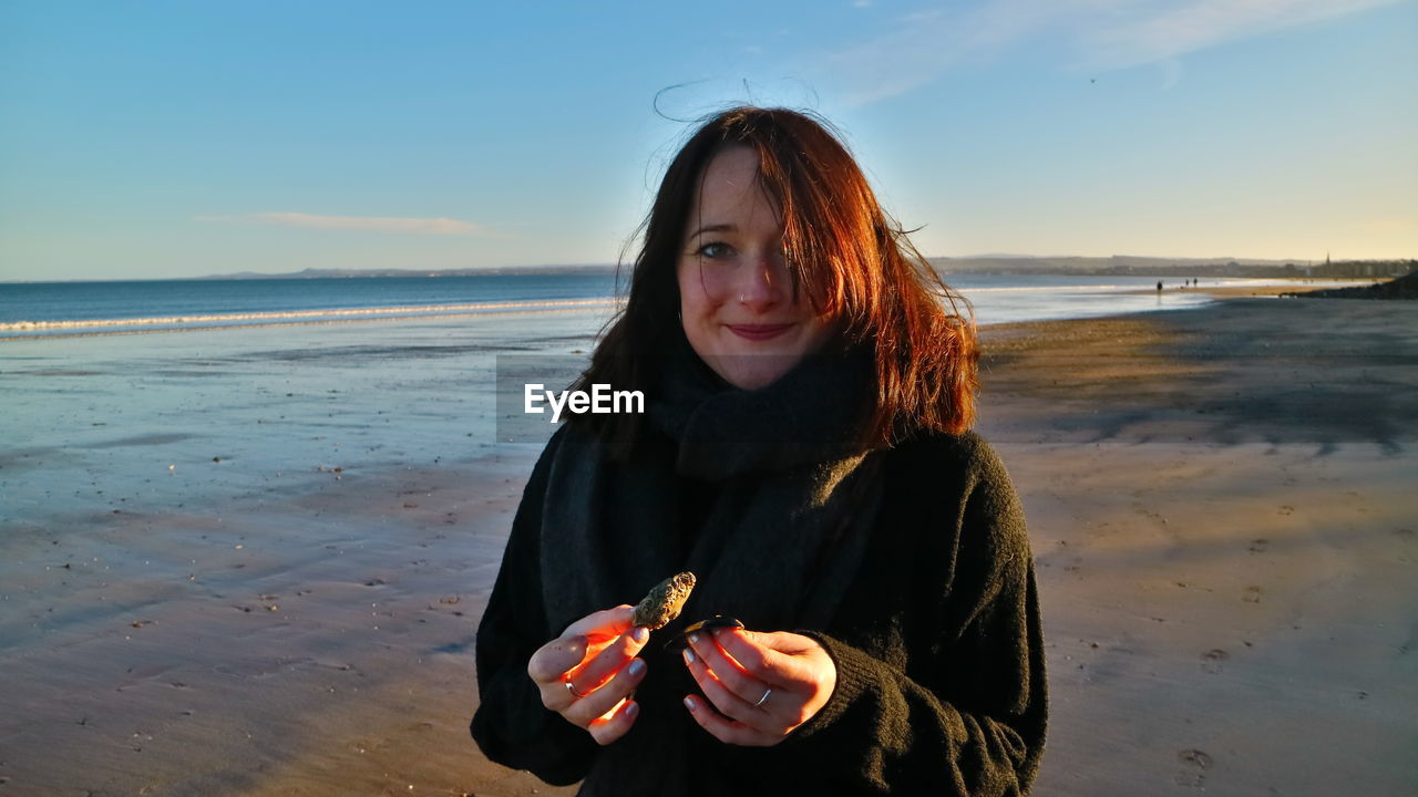 Portrait of beautiful young woman at beach