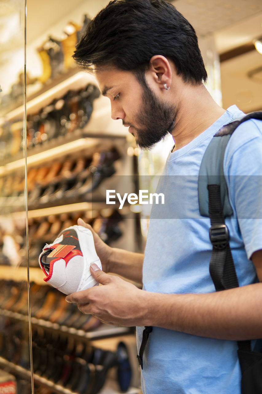 Man choosing shoes in market