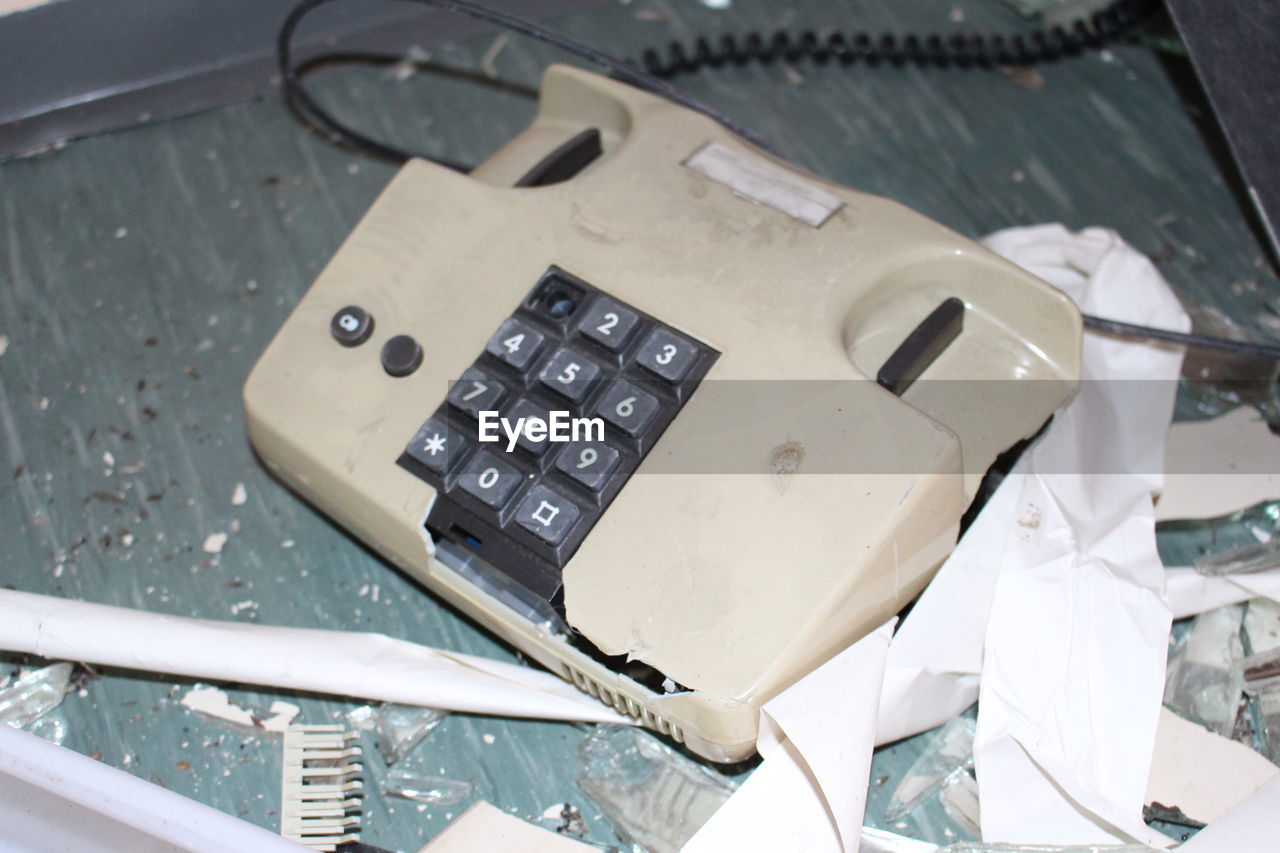 High angle view of damaged landline phone on table