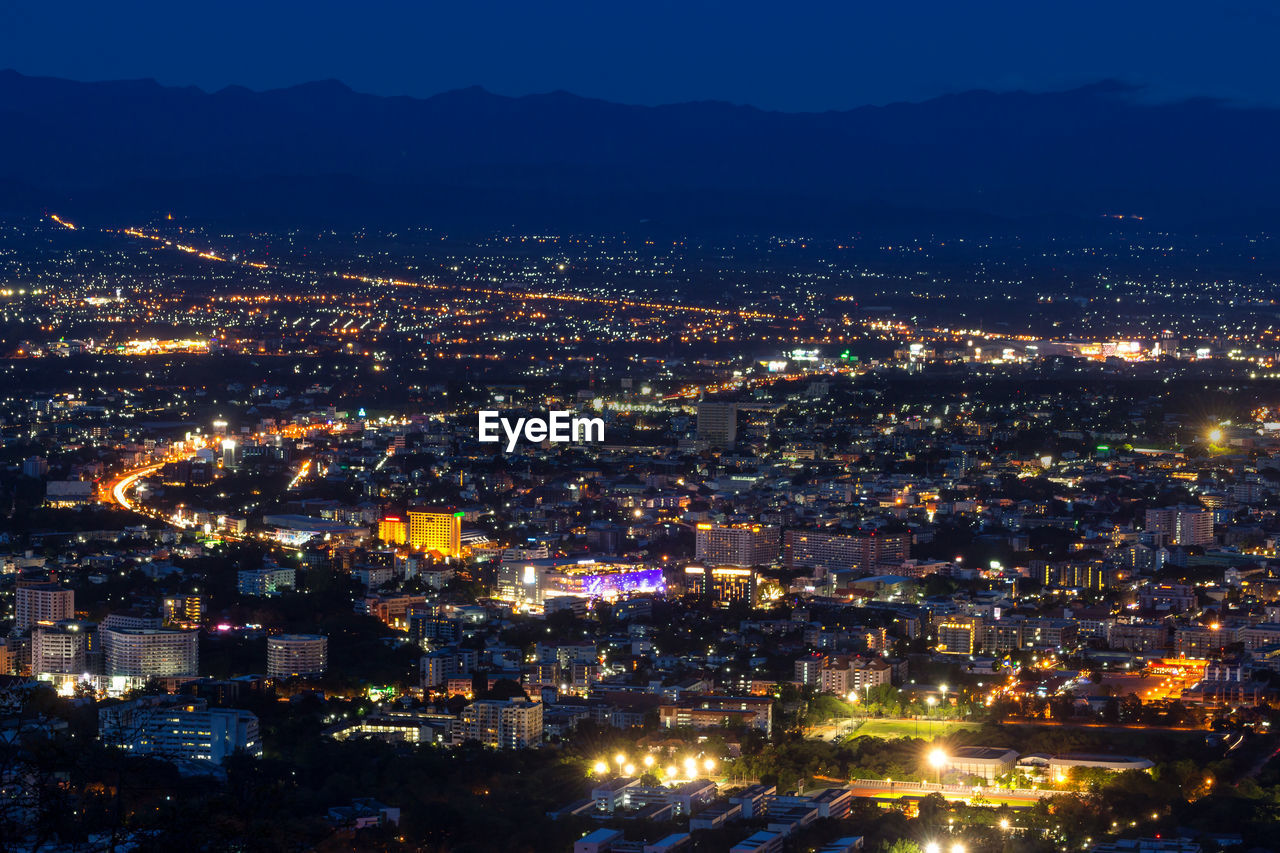 High angle view of illuminated city buildings at night