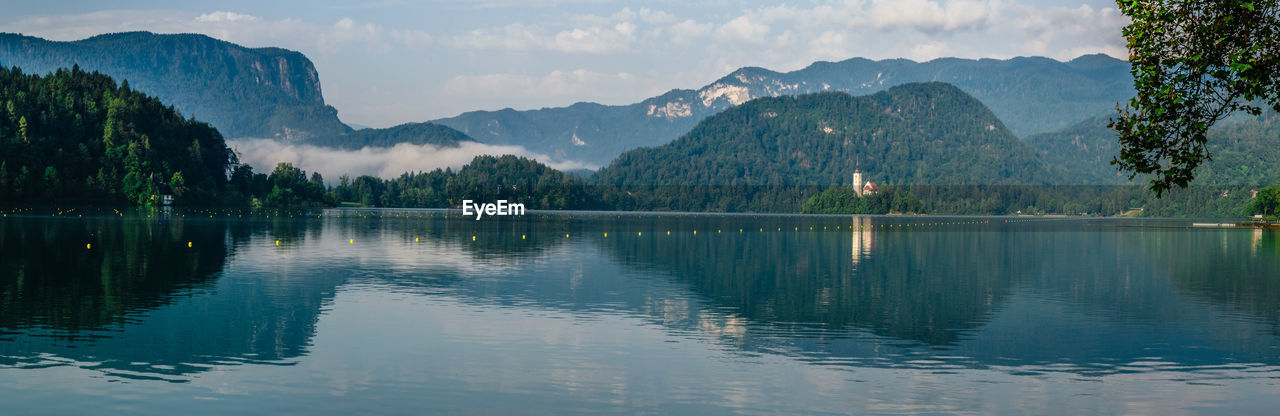 SCENIC VIEW OF LAKE WITH MOUNTAINS IN BACKGROUND