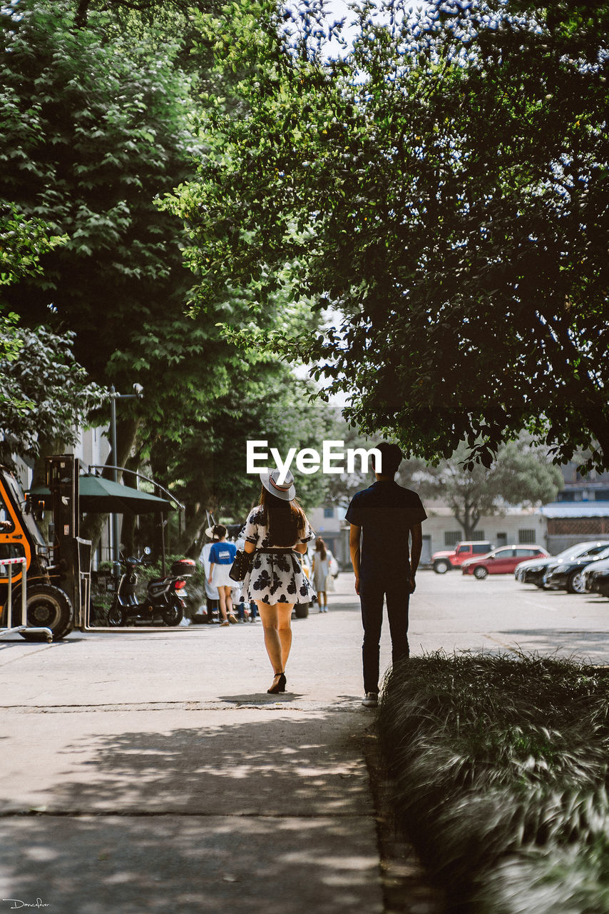 Rear view of people walking on street