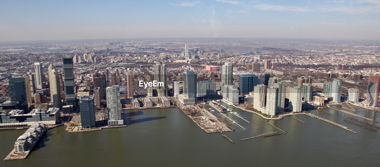 High angle view of river and cityscape against sky