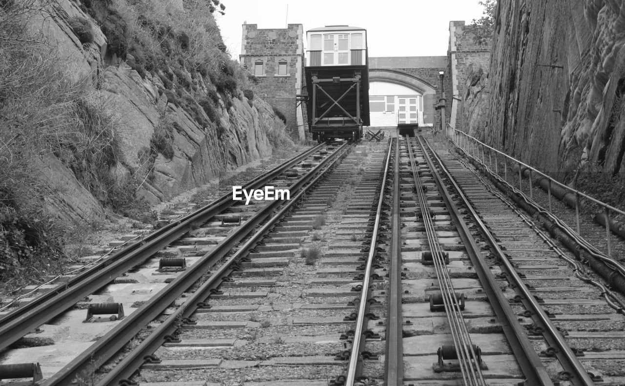 Railroad car on track amidst mountain