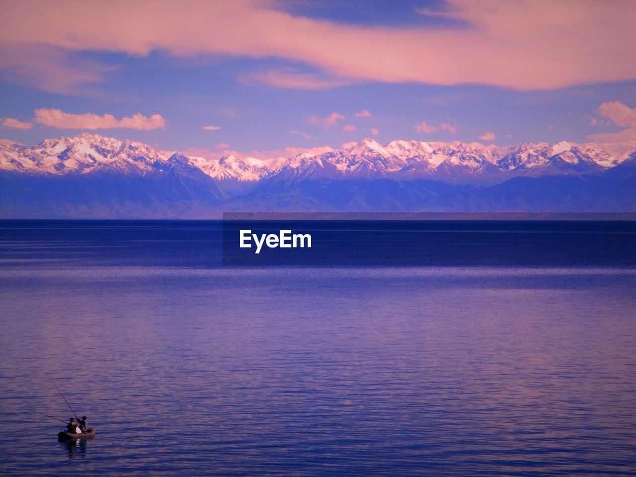 Scenic view of lake against cloudy sky