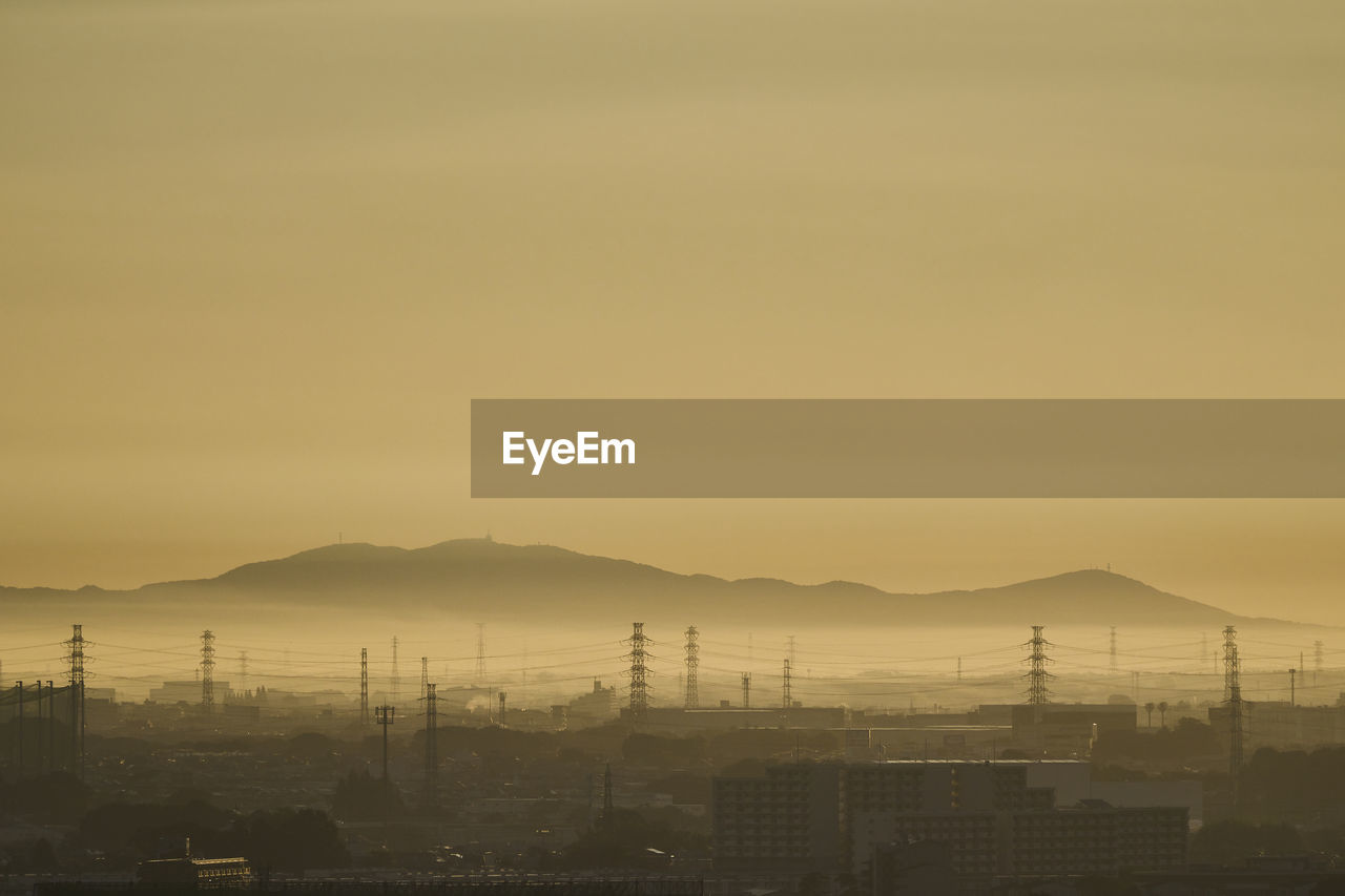 SILHOUETTE CITY AGAINST SKY DURING SUNSET