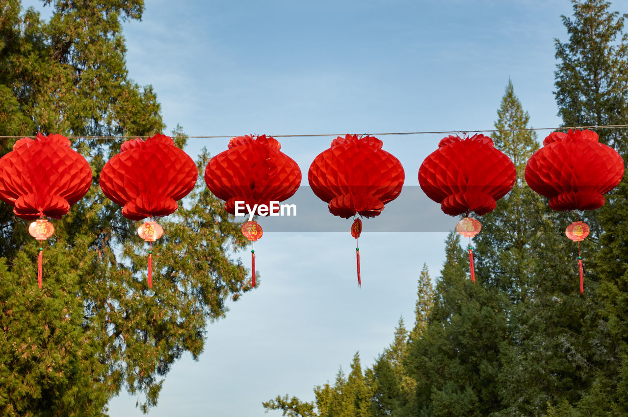 LOW ANGLE VIEW OF RED LANTERNS AGAINST SKY