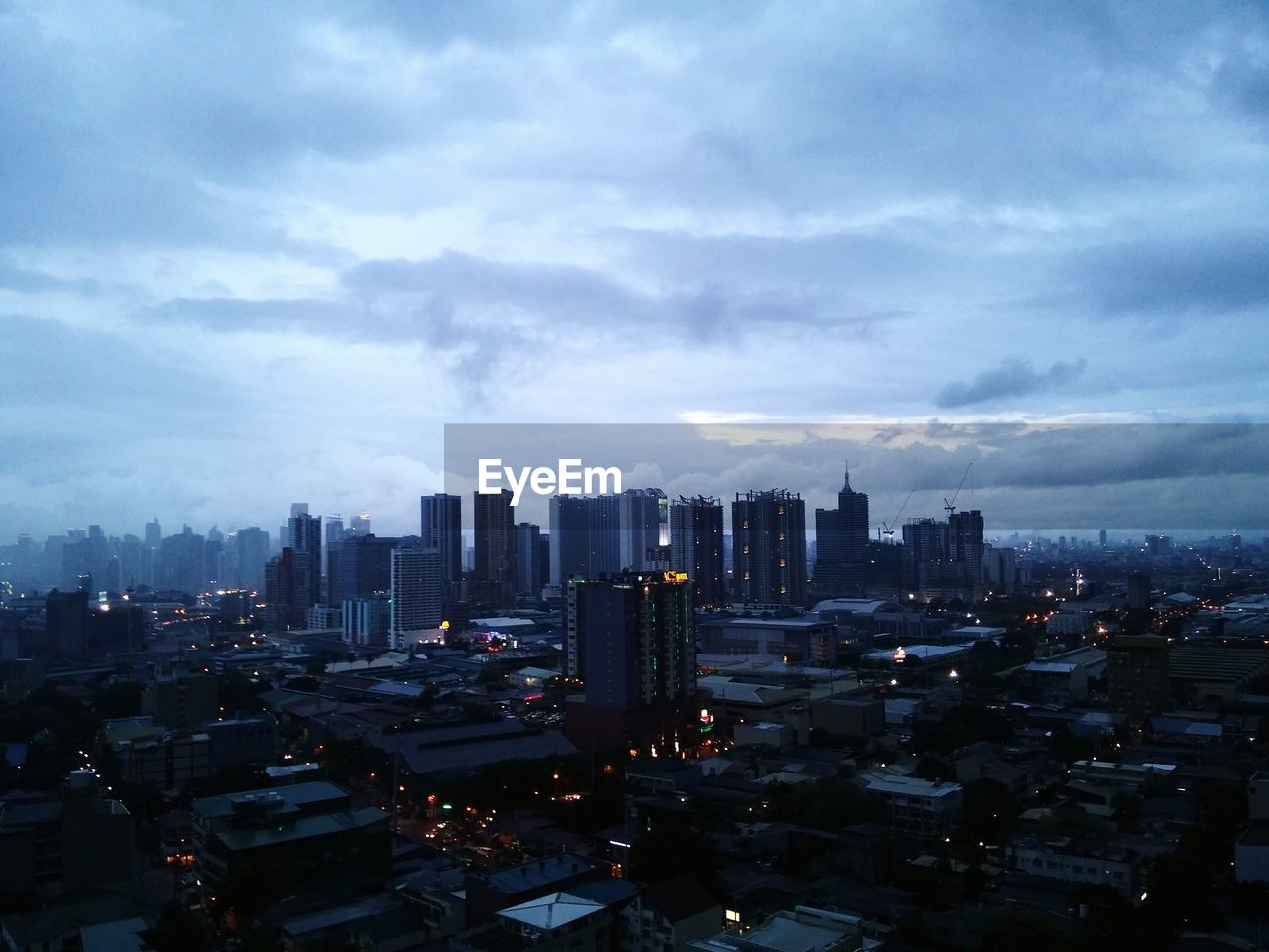 Cityscape against cloudy sky