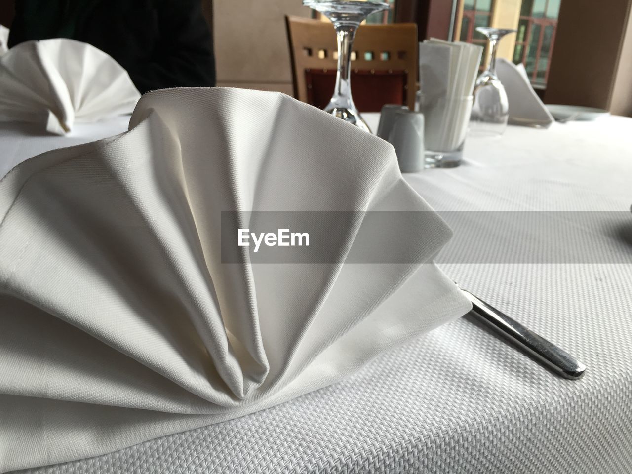 Napkins and knife on restaurant table