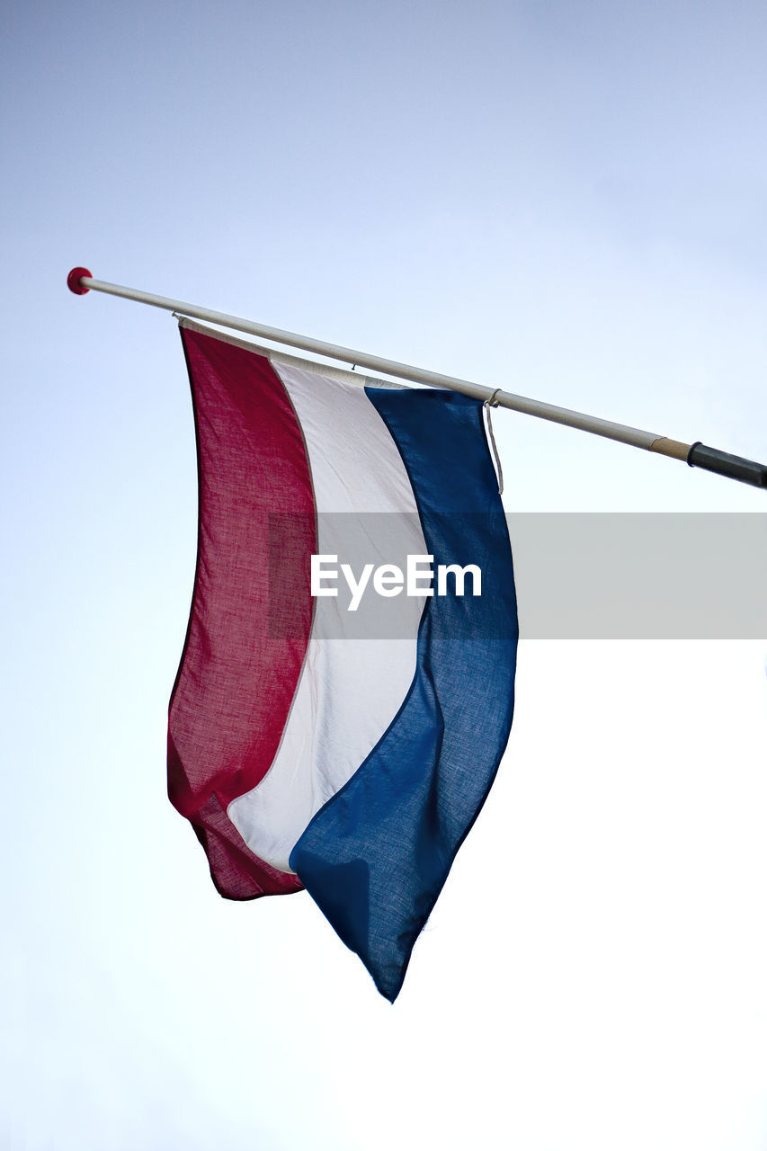 Low angle view of dutch flag against sky