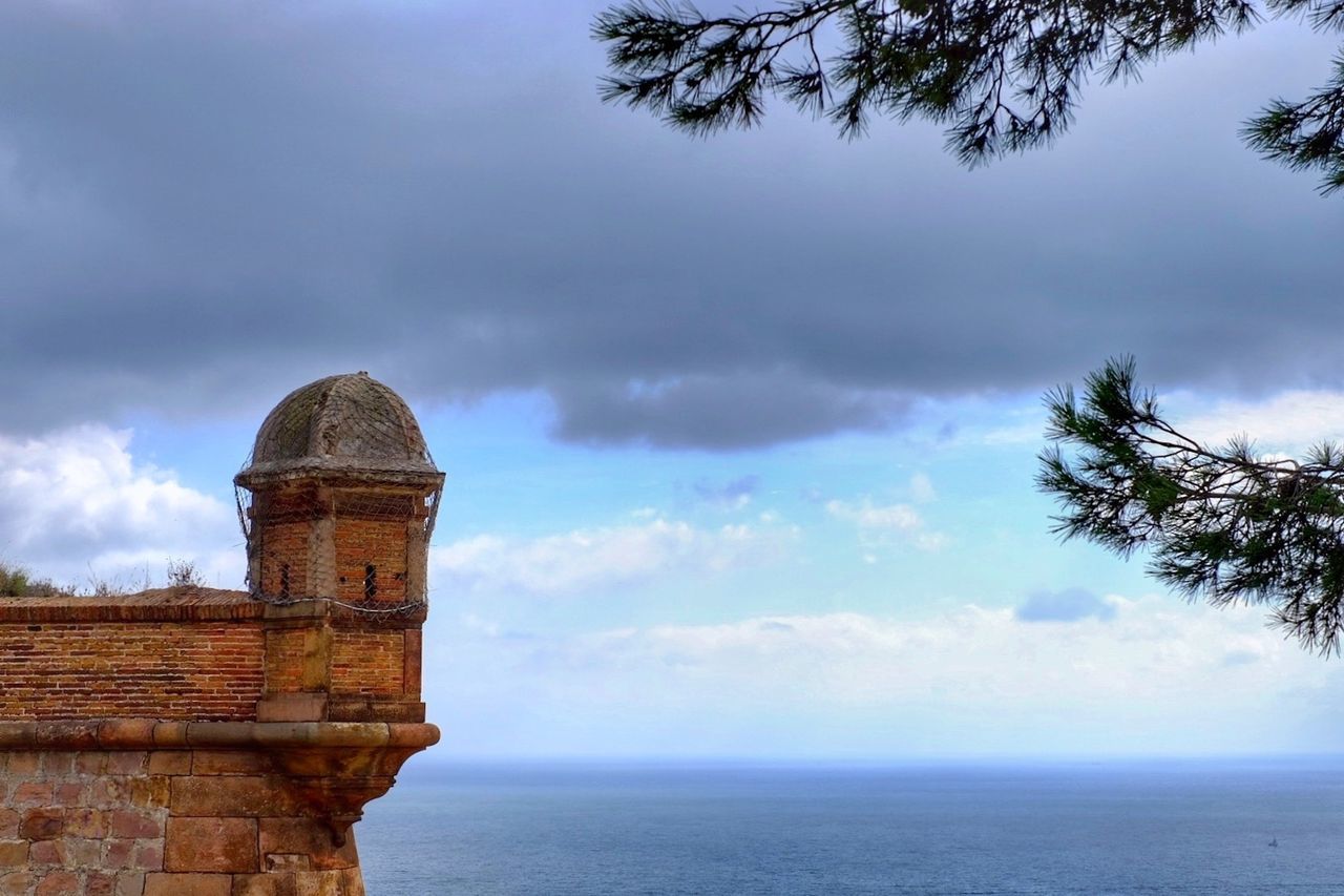 CASTLE AGAINST CLOUDY SKY