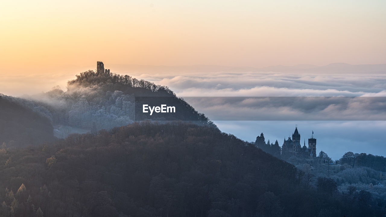 PANORAMIC VIEW OF BUILDINGS AGAINST SKY AT SUNSET