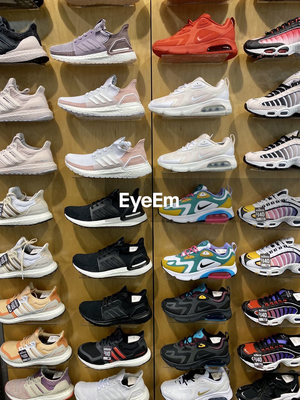 HIGH ANGLE VIEW OF VARIOUS SHOES FOR SALE AT MARKET