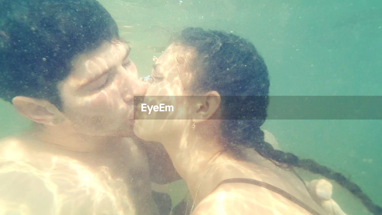 Close-up of couple kissing undersea