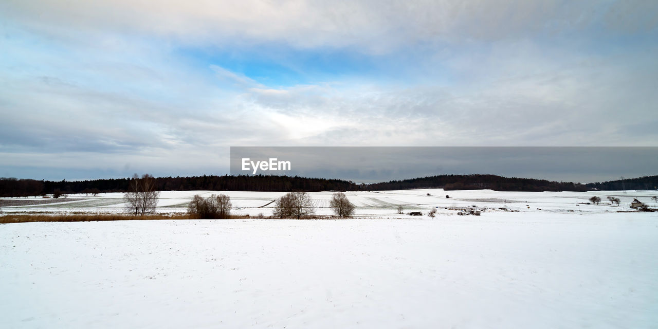 SNOW COVERED LAND AGAINST SKY