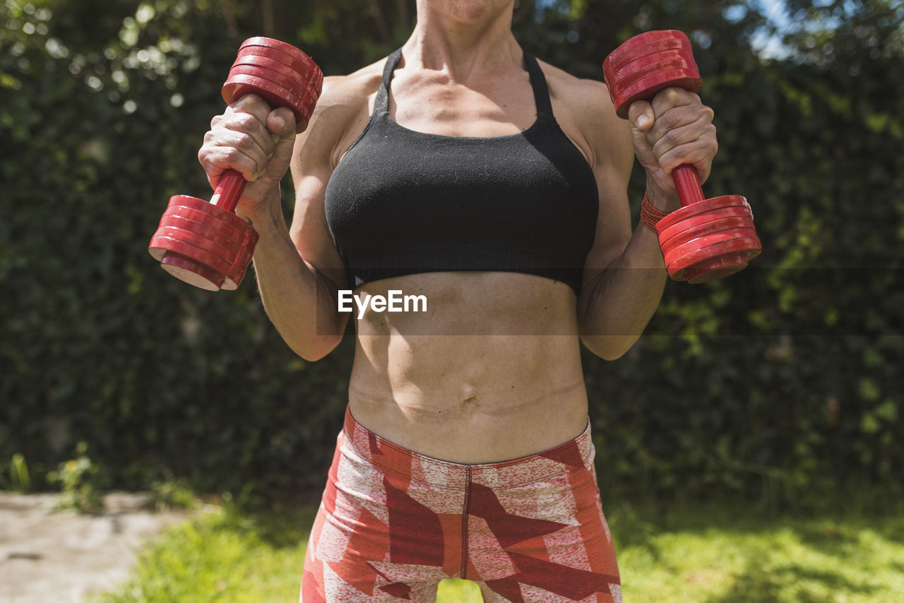 Woman training and stretching outdoors