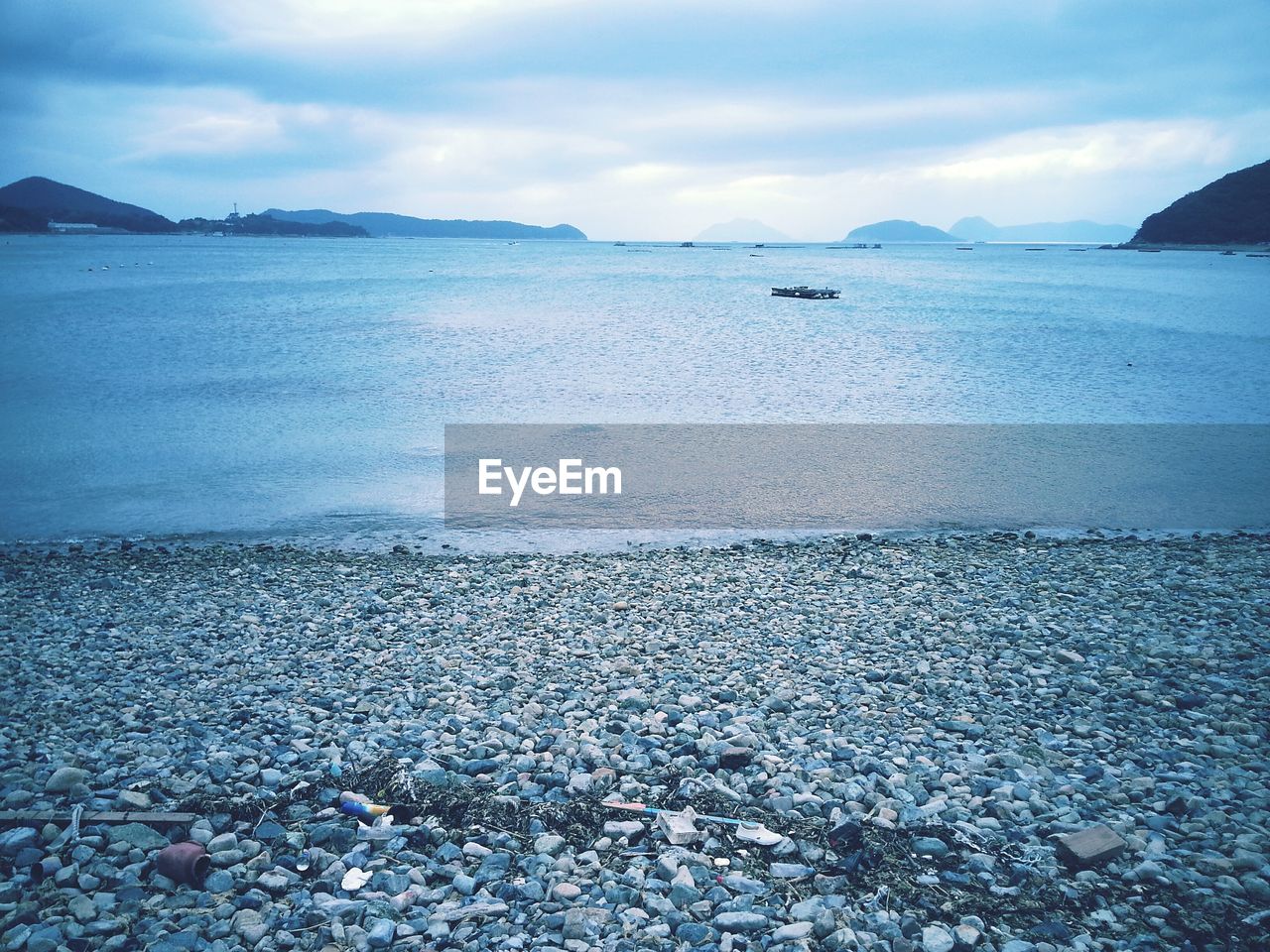 Scenic view of sea against cloudy sky