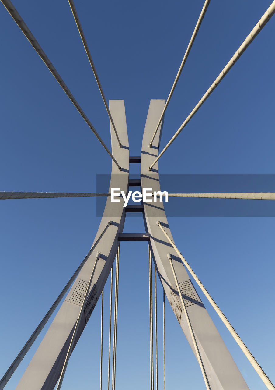 Low angle view of bridge against clear blue sky