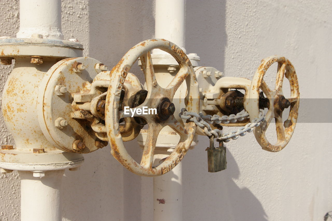 Close-up of rusty pipeline against wall