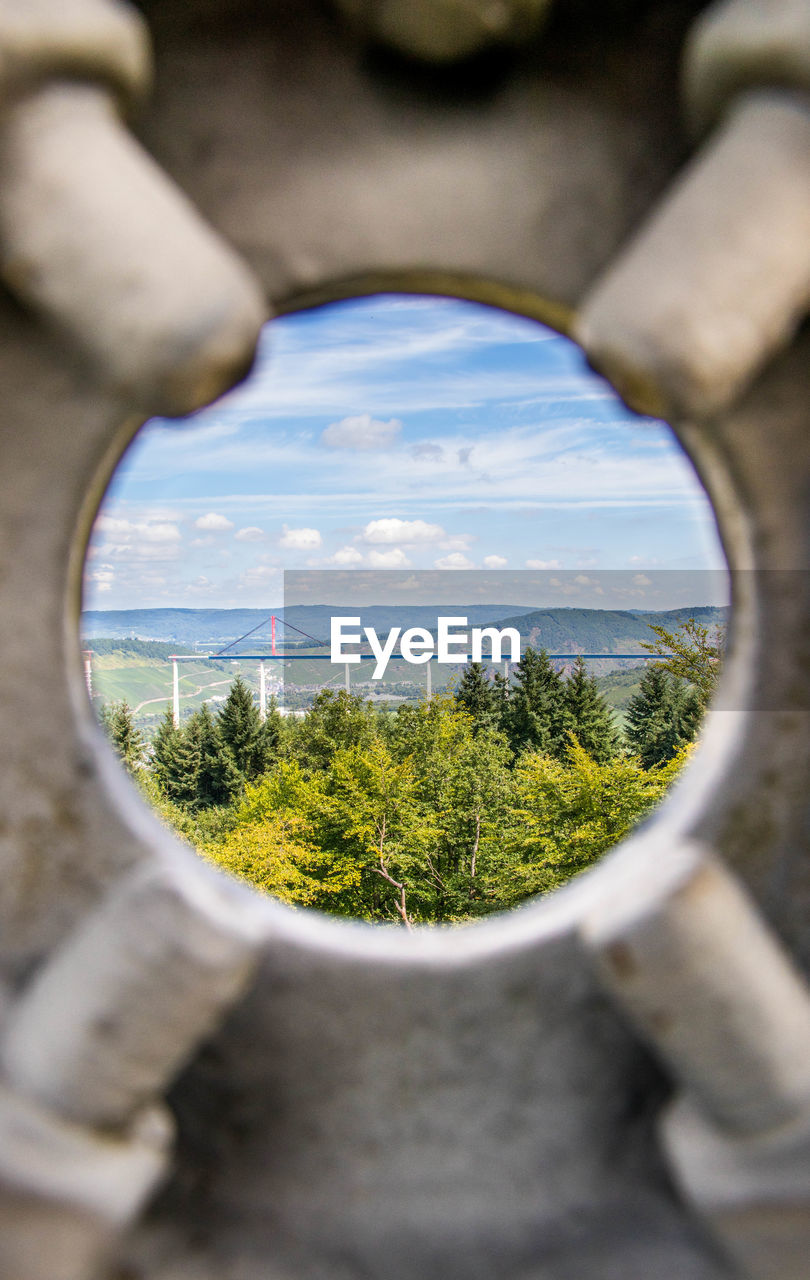 Bridge under construction through a hole with forest