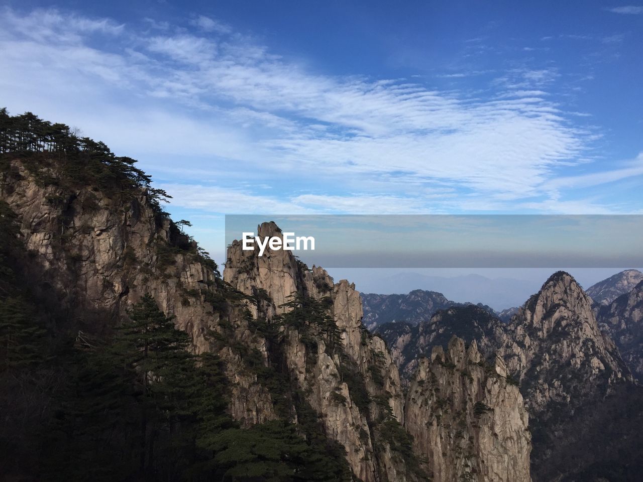 Scenic view of huangshan mountains against cloudy sky