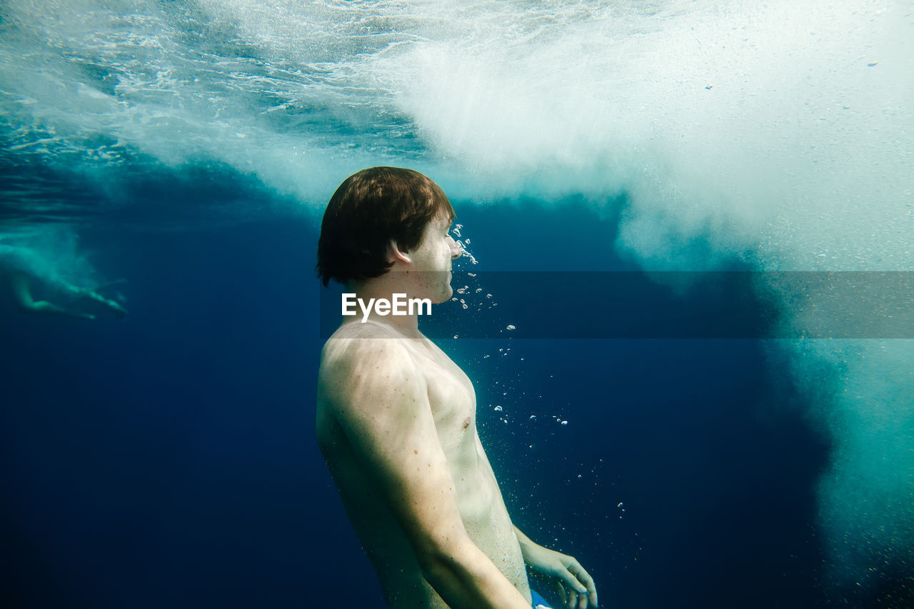 Mid adult woman swimming undersea