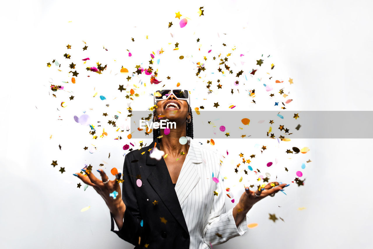 Portrait of smiling young woman against white background