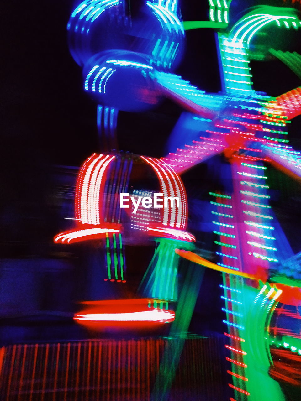 LOW ANGLE VIEW OF ILLUMINATED FERRIS WHEEL