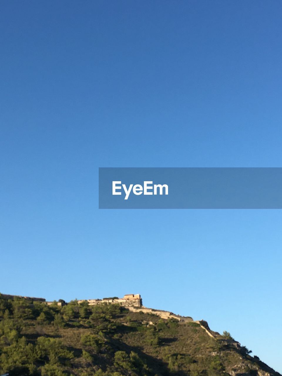 LOW ANGLE VIEW OF MOUNTAIN AGAINST BLUE SKY