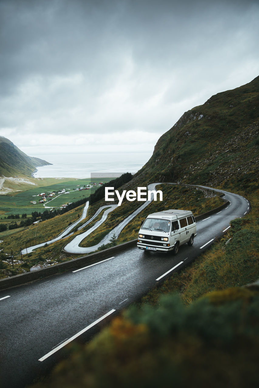 CAR ON ROAD AGAINST SKY