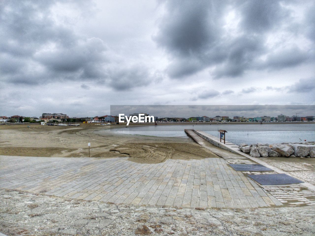 Pier over city against sky