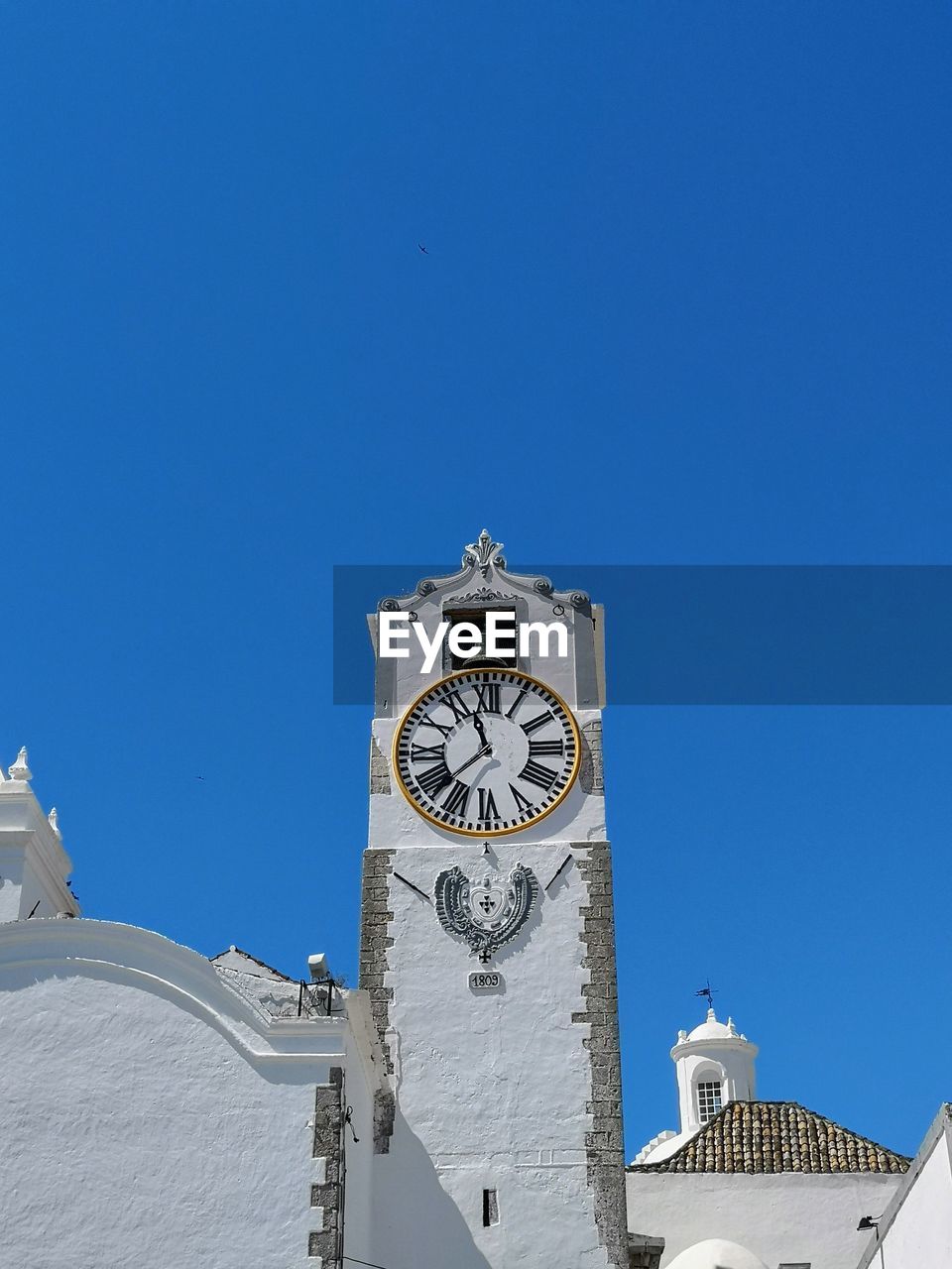 Low angle view of clock tower against sky