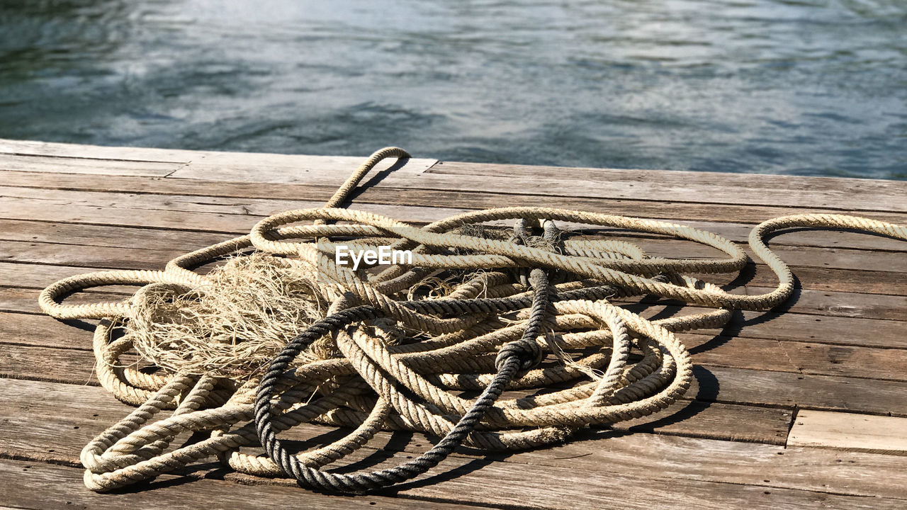 High angle view of rope tied to pier