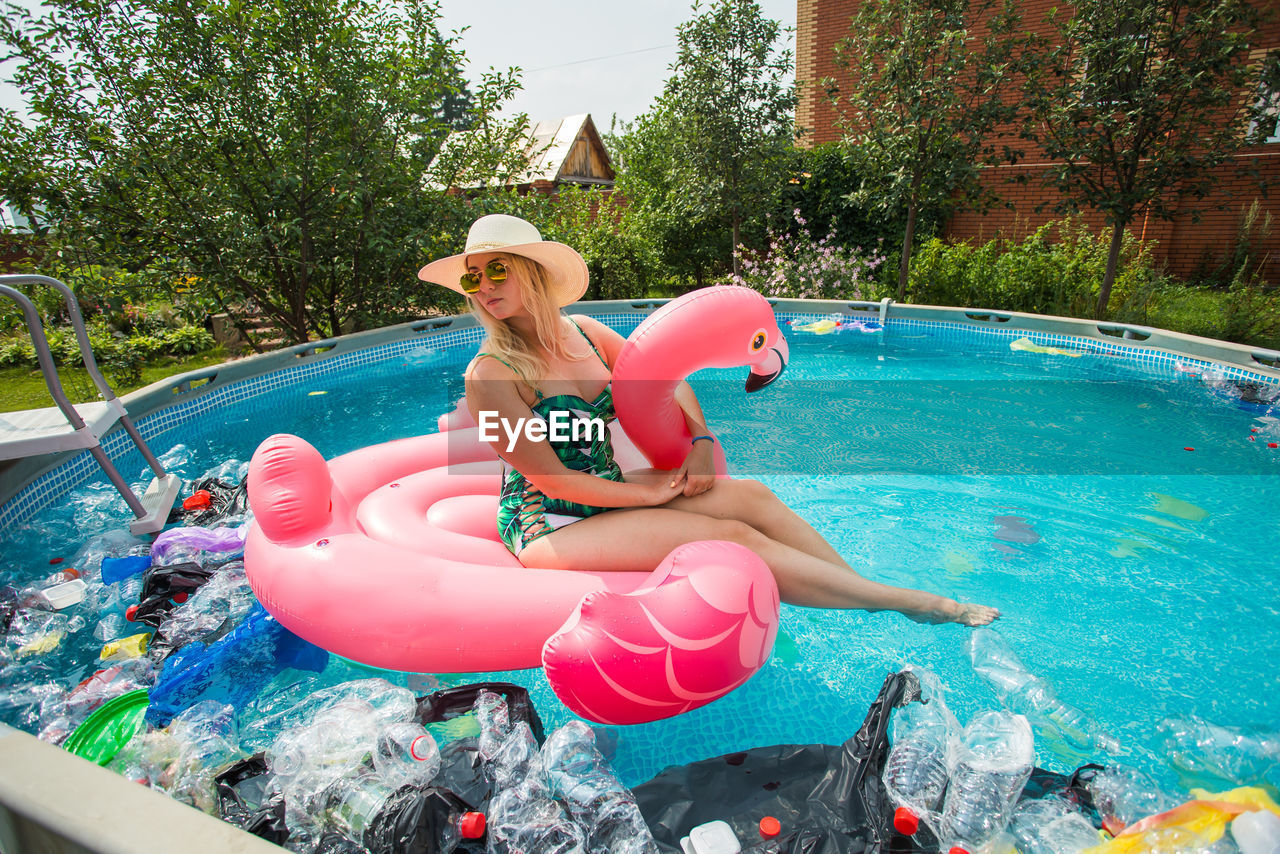 VIEW OF WOMAN IN POOL