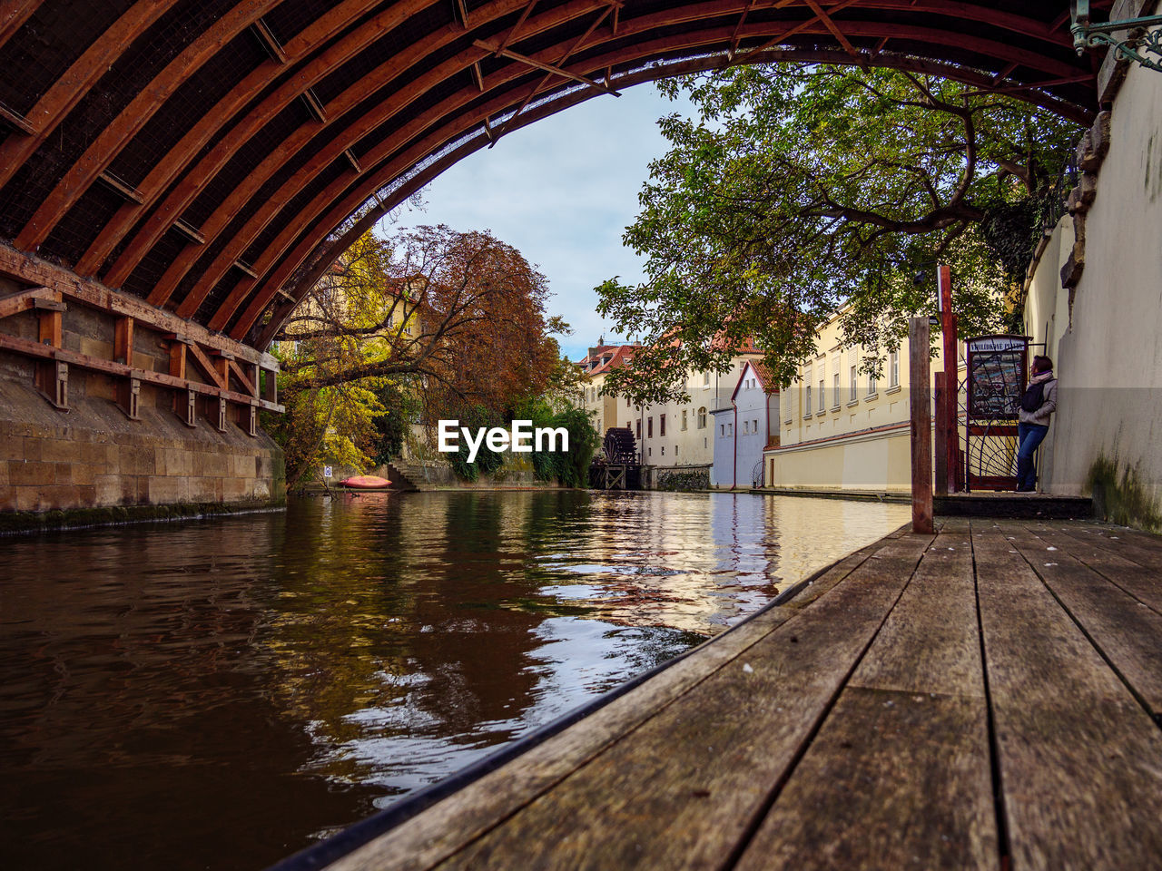 Full length of woman standing by canal