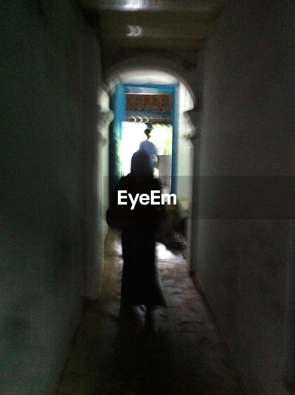 WOMAN WALKING IN TUNNEL
