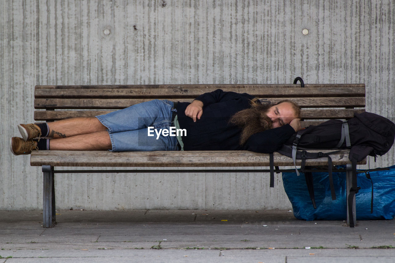 MAN SLEEPING ON FLOOR IN A ROOM