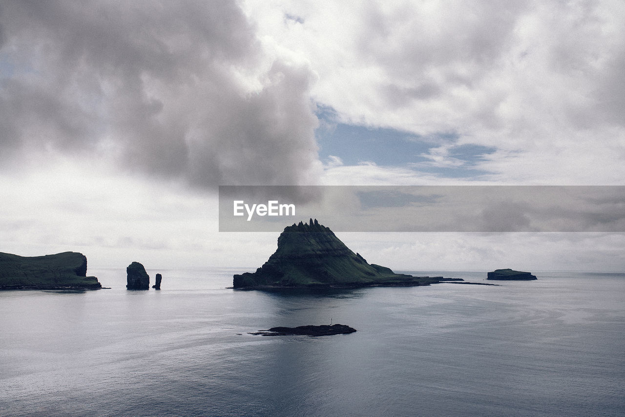 Scenic view of calm sea against cloudy sky