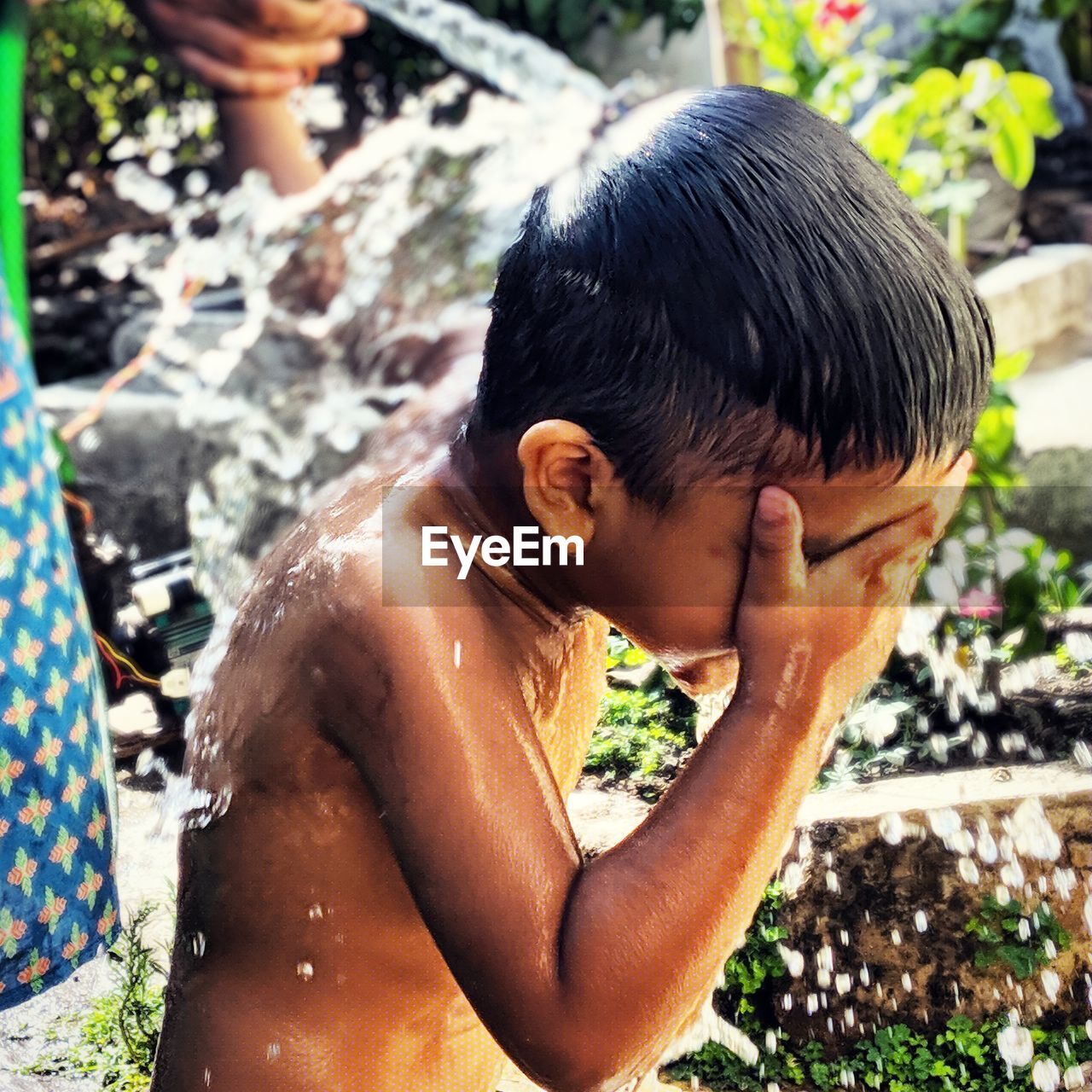 SHIRTLESS BOY IN WATER