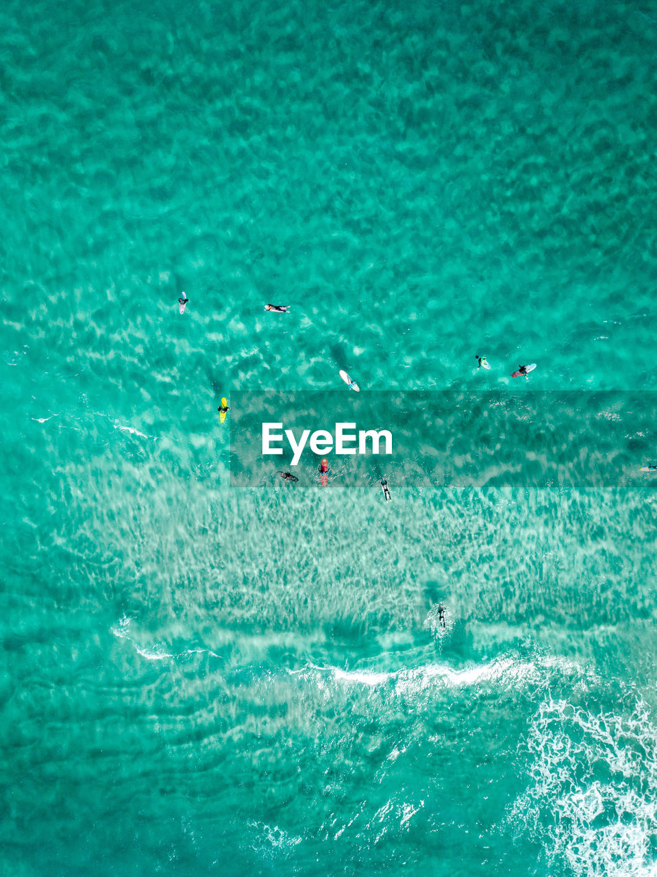 Aerial view of people swimming in sea